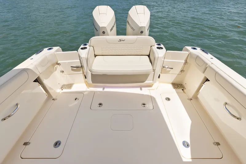 Slide: The Image of The image shows the stern of a Scout 288 Dorado boat with two outboard engines. - 7