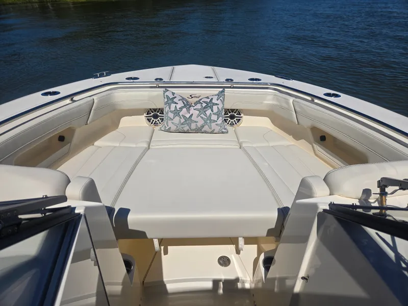 Slide: The Image of The image shows the bow of a Scout 288 Dorado boat with comfortable seating. - 22