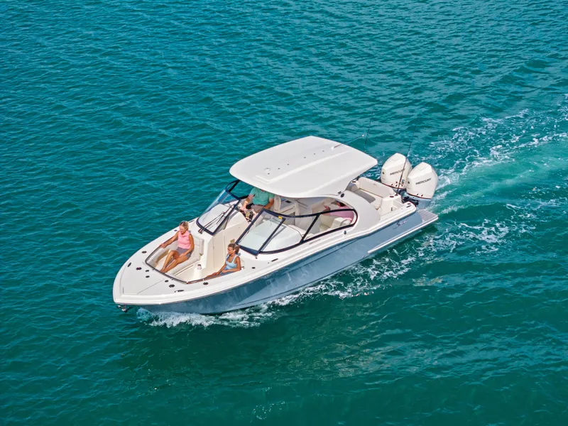 Slide: The Image of A modern motorboat cruising on clear blue water. It features a sleek design and twin outboard engines. - 8