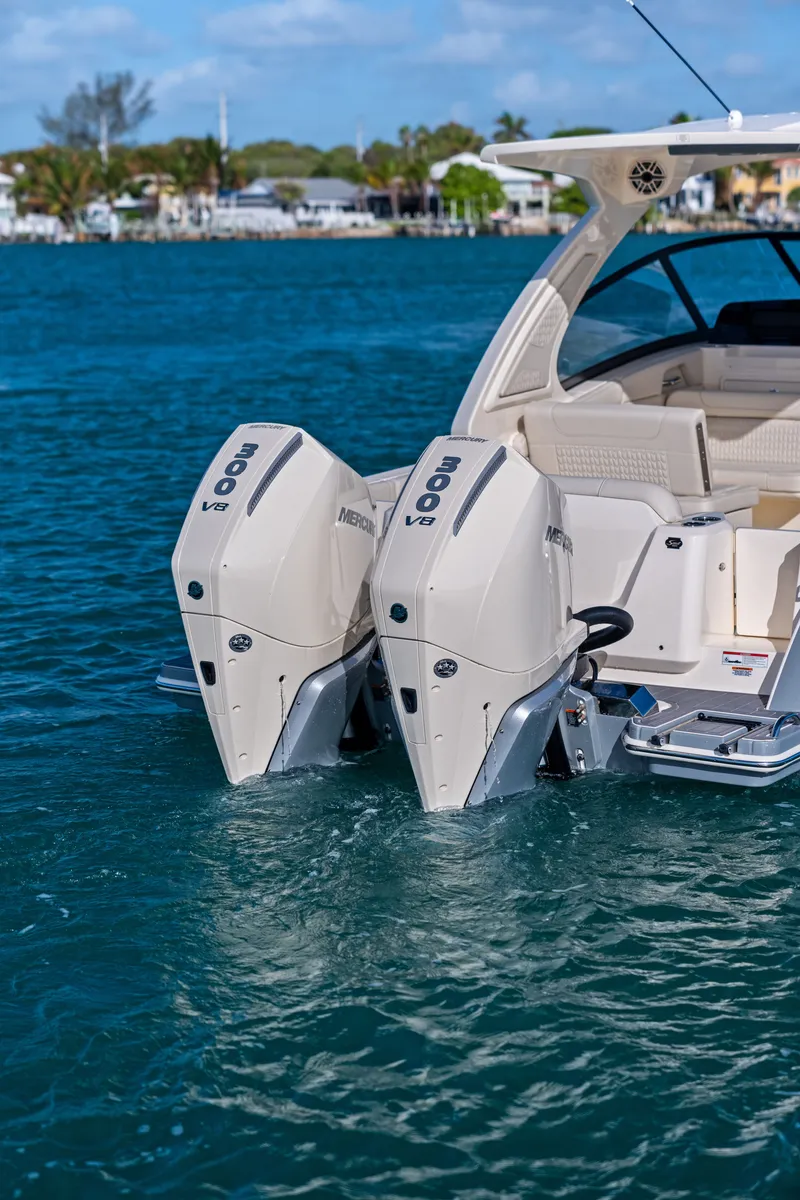 Slide: The Image of The image shows a Scout 288 Dorado boat with twin outboard engines on calm water. - 6
