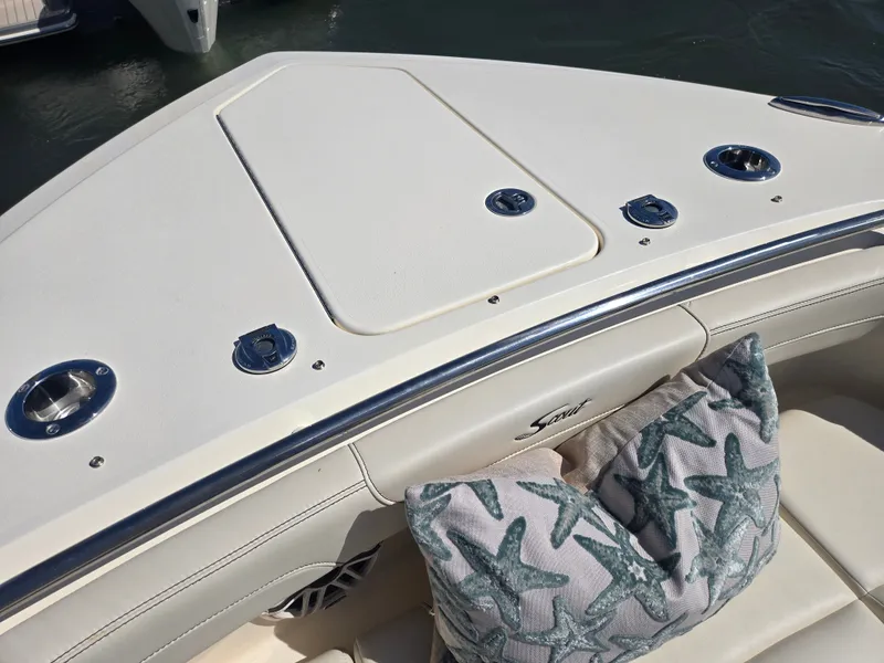 Slide: The Image of The image shows the bow of a Scout 288 Dorado boat with starfish-patterned cushions. - 23