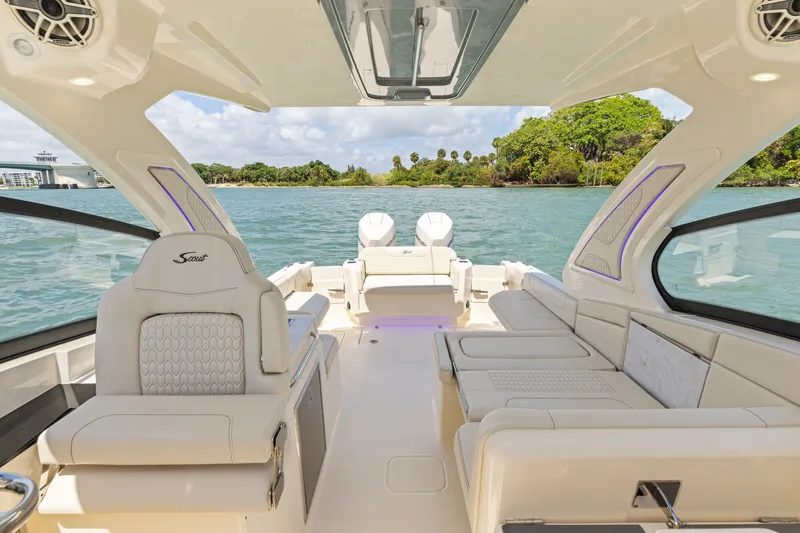 Slide: The Image of The image shows the luxurious cockpit of a Scout 288 Dorado boat with elegant seating and a clear view of the water. - 4