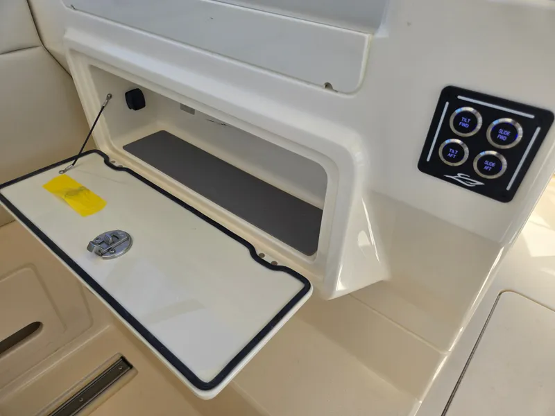 Slide: The Image of An open storage compartment with a lid and a control panel beside it. - 12