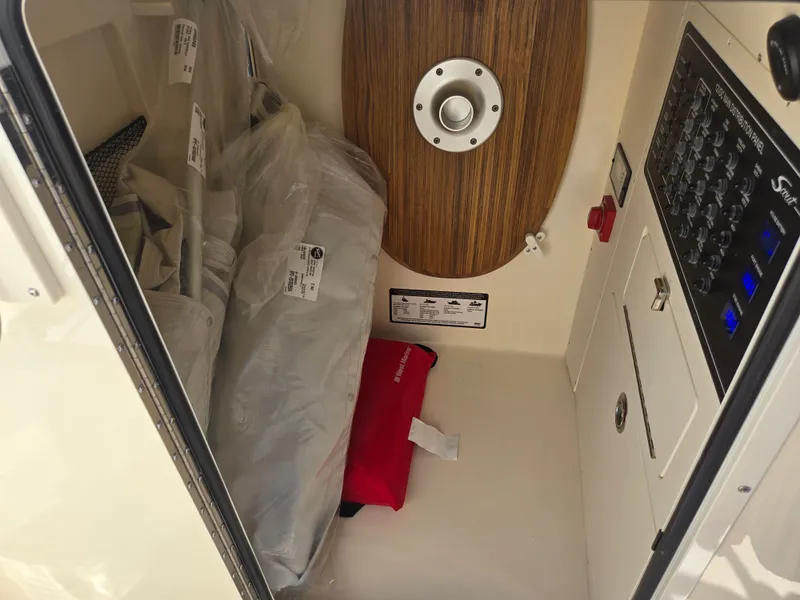 Slide: The Image of Interior of a boat with wood paneling, control panel, and stored items. - 21