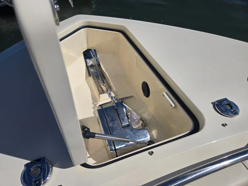 Slide: The Image of An anchor locker on a Scout 288 Dorado boat, showing a shiny anchor and fittings. - 24