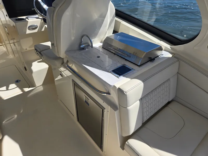 Slide: The Image of The 2027 Scout 288 Dorado features an elegant outdoor kitchen with a grill and sink. - 13