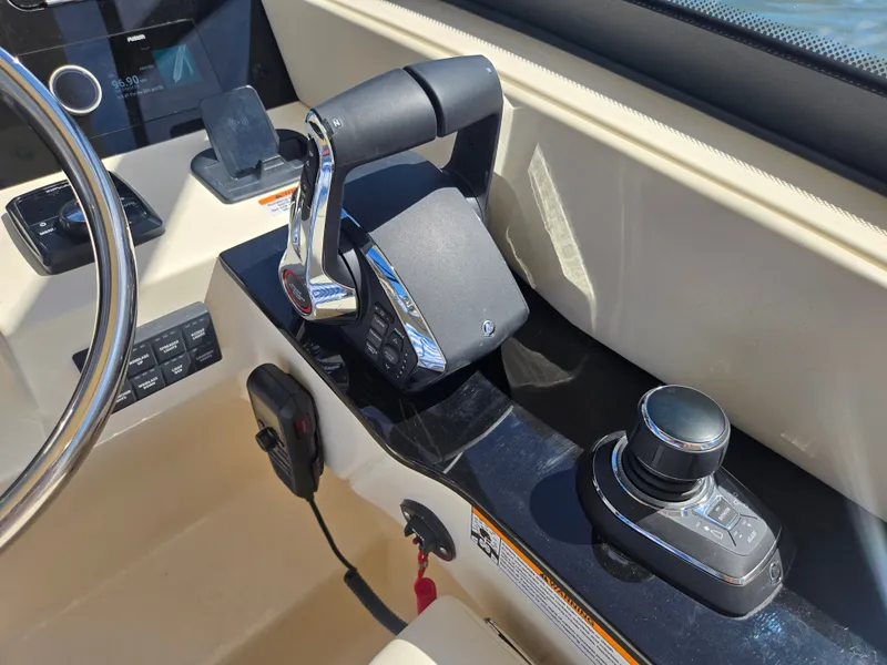 Slide: The Image of Close-up of the helm of a Scout 288 Dorado boat with modern controls. - 18