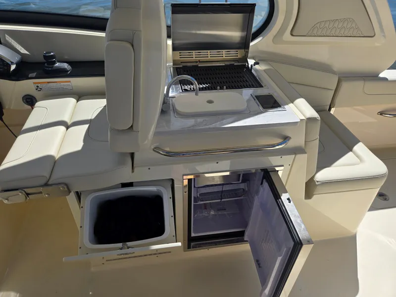 Slide: The Image of The 2027 Scout 288 Dorado features a sleek interior with a refrigerator and sink. - 14