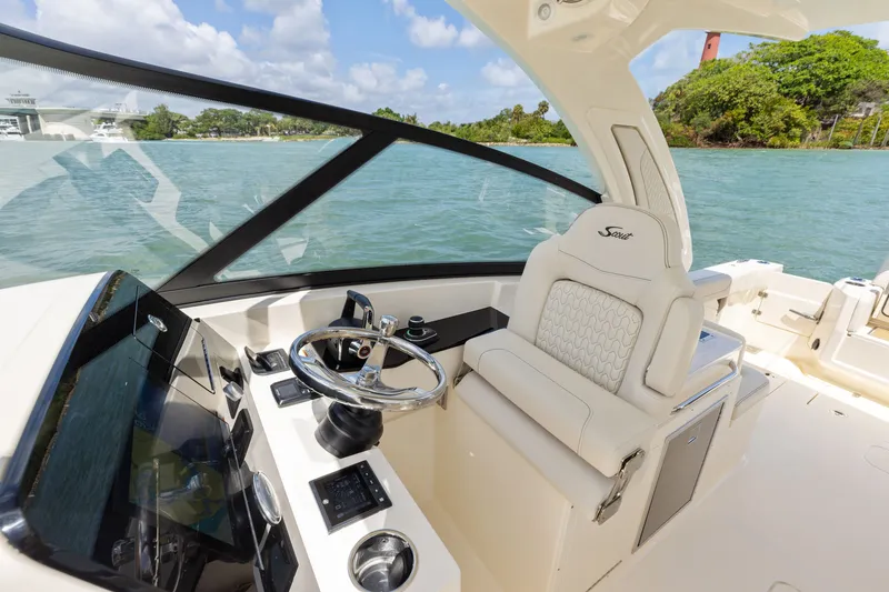 Slide: The Image of The image shows the cockpit of a 2027 Scout 288 Dorado boat with a sleek helm station. - 2