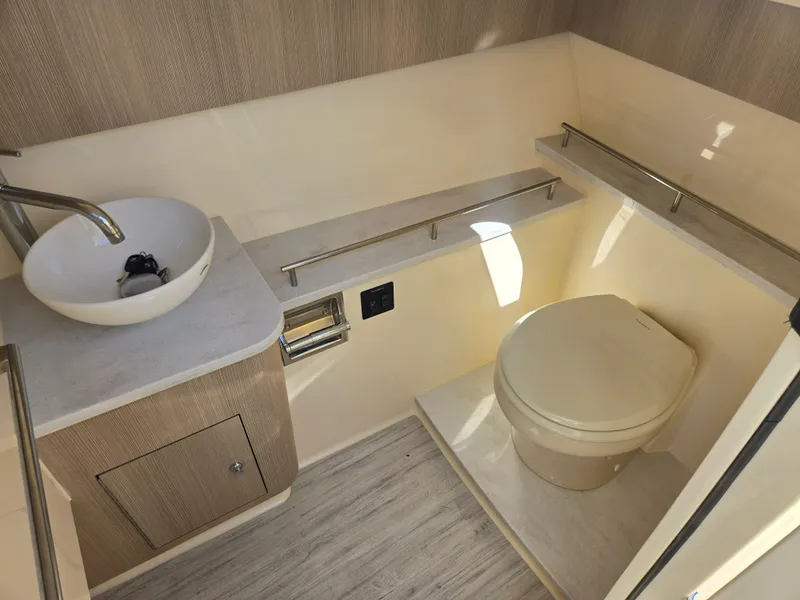 Slide: The Image of The image shows a modern boat bathroom with a sink and toilet. - 20