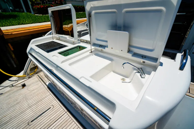 Slide: The Image of Outdoor kitchen area on a 2017 Azimut 42 Fly yacht, featuring a sink and grill. - 11