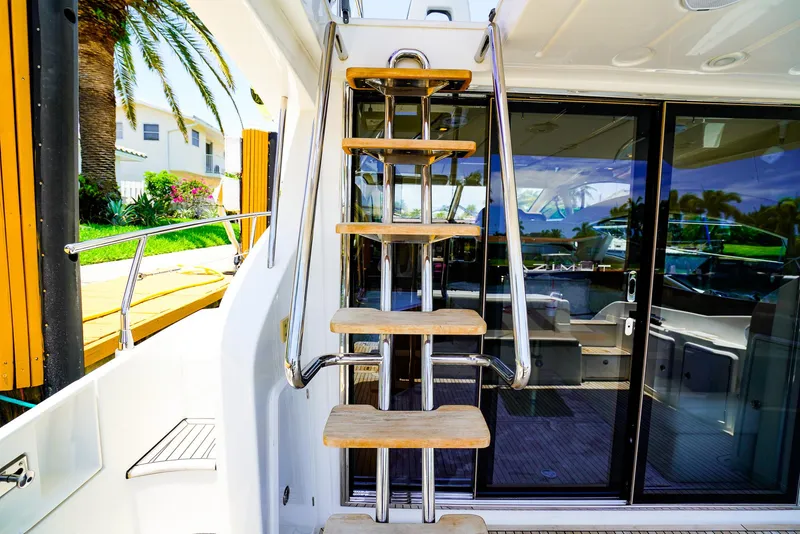 Slide: The Image of Staircase on 2017 Azimut 42 Fly yacht, leading to upper deck with glass doors. - 13