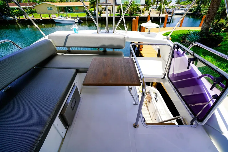 Slide: The Image of Flybridge of 2017 Azimut 42 Fly yacht with seating and table, overlooking waterway. - 14