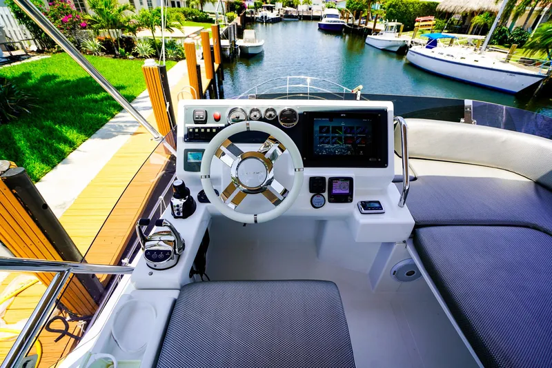 Slide: The Image of Cockpit of 2017 Azimut 42 Fly yacht with modern controls and waterfront view. - 18