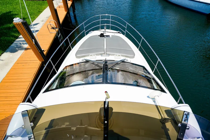 Slide: The Image of 2017 Azimut 42 Fly yacht docked in a serene marina setting. - 21