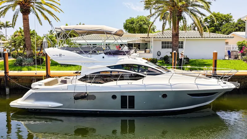 Slide: The Image of 2017 Azimut 42 Fly yacht docked by palm trees and a house. - 3