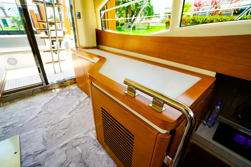 Slide: The Image of Interior of 2017 Azimut 42 Fly yacht with modern wood cabinetry and large windows. - 32