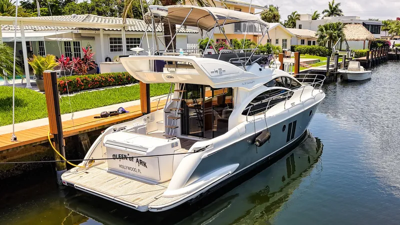 Slide: The Image of 2017 Azimut 42 Fly yacht docked in a sunny canal setting. - 4