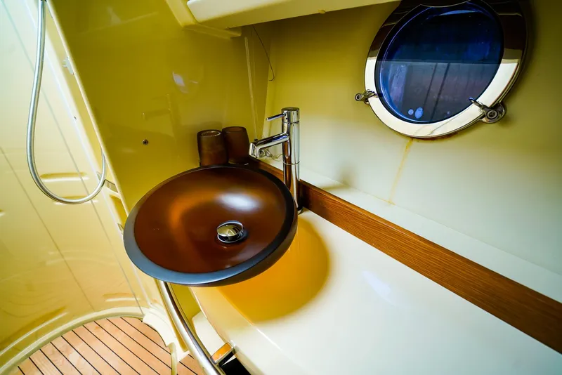 Slide: The Image of Luxurious bathroom sink on 2017 Azimut 42 Fly yacht with porthole view. - 46
