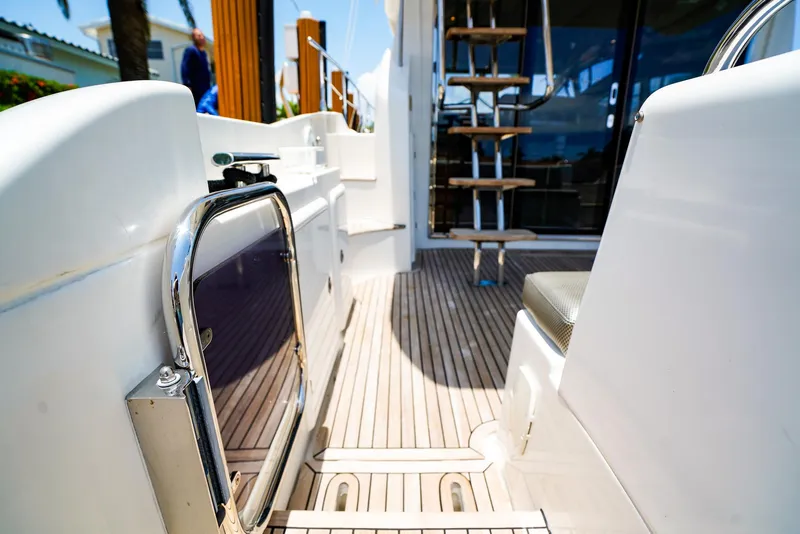 Slide: The Image of Azimut 42 Fly 2017 yacht deck with wooden flooring and metal railings. - 7