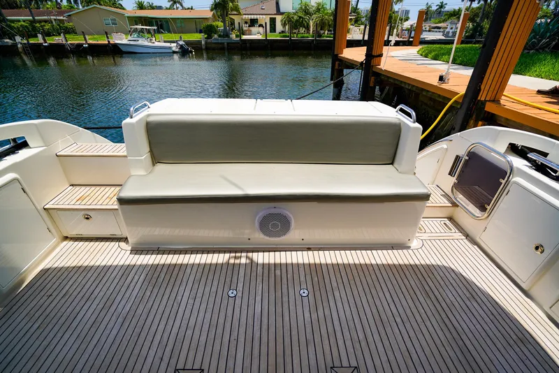 Slide: The Image of Azimut 42 Fly 2017 yacht deck with cushioned seating and waterfront view. - 9