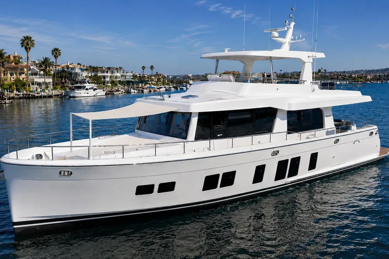 The Image of Luxury 2026 Offshore Yachts CE Series cruising in a scenic marina setting. - 0