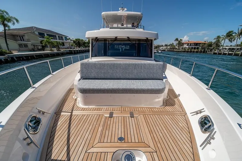 Slide: The Image of 2026 Offshore Yachts CE Series on water, featuring spacious deck and seating area. - 13