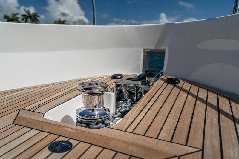 Slide: The Image of 2026 Offshore Yachts CE Series deck with anchor chain and winch, under clear blue sky. - 15