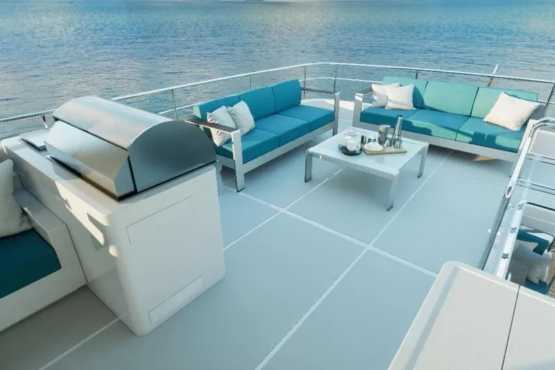 Slide: The Image of Luxurious 2026 Offshore Yachts CE Series deck with seating and grill, overlooking serene ocean. - 19