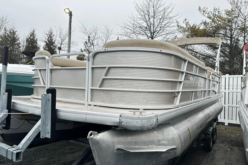 The Image of 2019 Godfrey Sweetwater 2386 C pontoon boat on trailer, parked outdoors. - 0