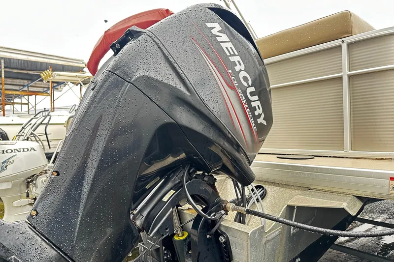 Slide: The Image of 2019 Godfrey Sweetwater 2386 C with Mercury outboard motor in a marina setting. - 10
