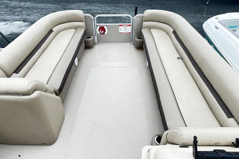 Slide: The Image of 2019 Godfrey Sweetwater 2386 C pontoon boat interior with beige seating. - 4