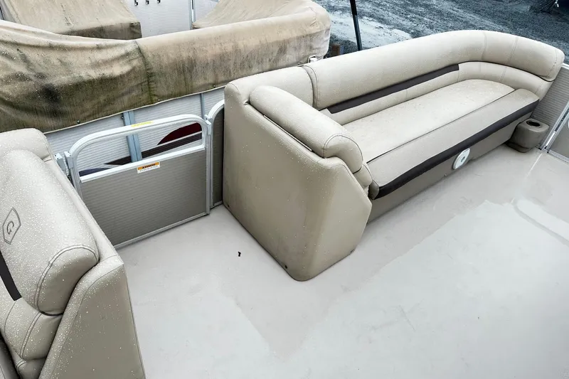 Slide: The Image of 2019 Godfrey Sweetwater 2386 C pontoon boat interior with beige seating and wet floor. - 5