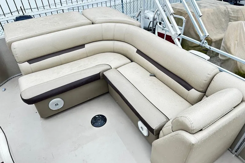 Slide: The Image of 2019 Godfrey Sweetwater 2386 C boat seating with beige upholstery and integrated speakers. - 6