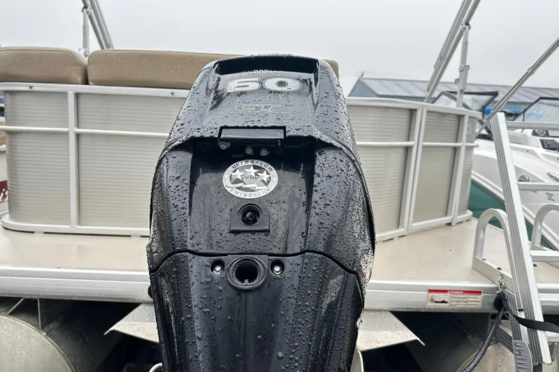 Slide: The Image of 2019 Godfrey Sweetwater 2386 C boat with a 60 HP outboard motor, wet with rain. - 9