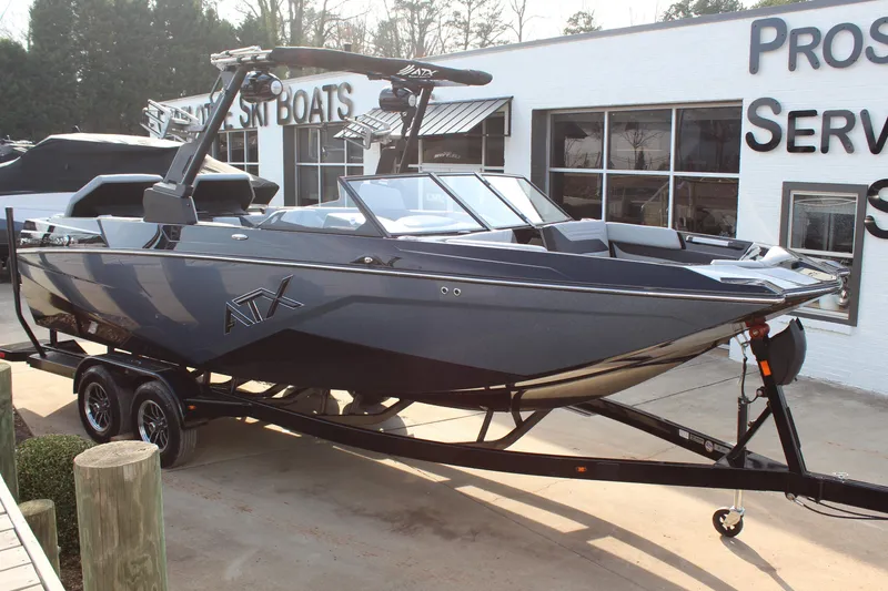 The Image of 2026 ATX Surf Boats 24 Type-S, sleek design, parked on trailer outside dealership. - 0