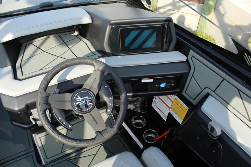 Slide: The Image of 2026 ATX Surf Boats 24 Type-S dashboard with steering wheel and touchscreen display. - 14