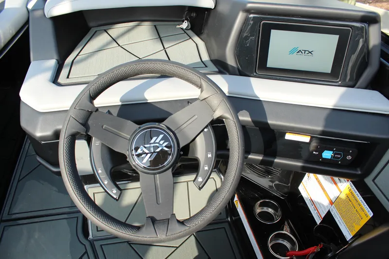 Slide: The Image of Interior of 2026 ATX Surf Boats 24 Type-S with steering wheel and touchscreen display. - 15