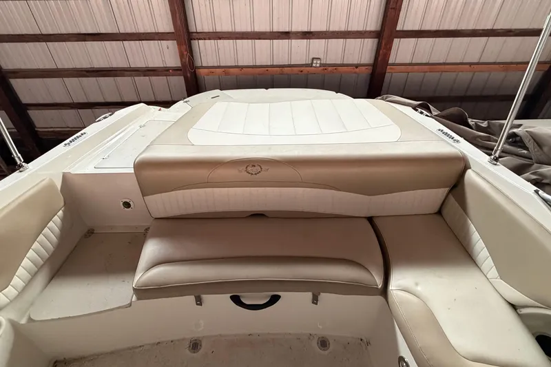 Slide: The Image of 2019 Stingray 208 LS boat interior with beige seating under a wooden roof. - 15