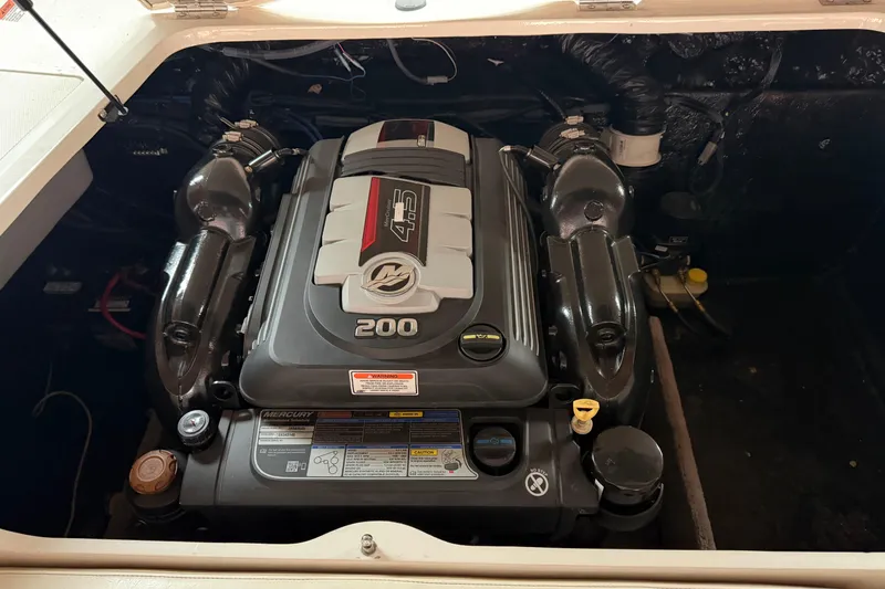 Slide: The Image of 2019 Stingray 208 LS boat engine compartment with Mercury 4.5L 200 HP engine. - 19