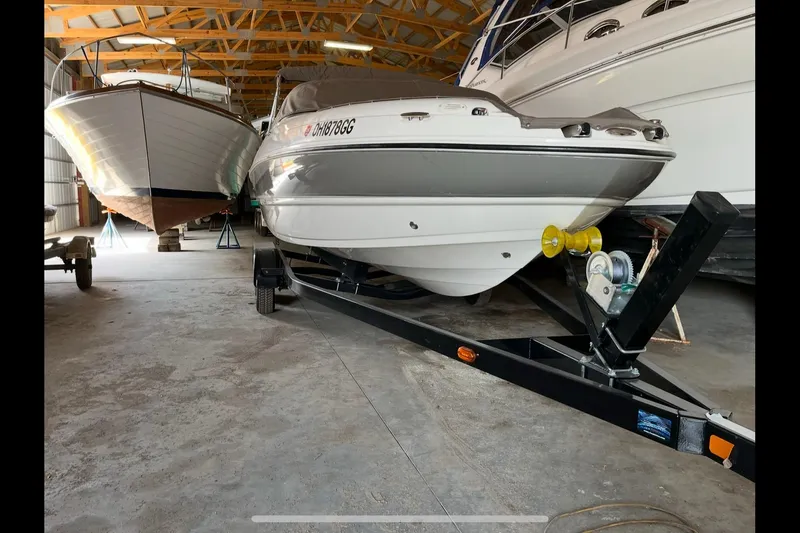 Slide: The Image of 2019 Stingray 208 LS boat on trailer in storage facility. - 2
