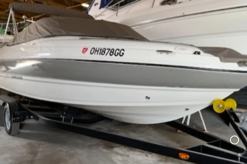 Slide: The Image of 2019 Stingray 208 LS boat on trailer, covered and parked indoors. - 4