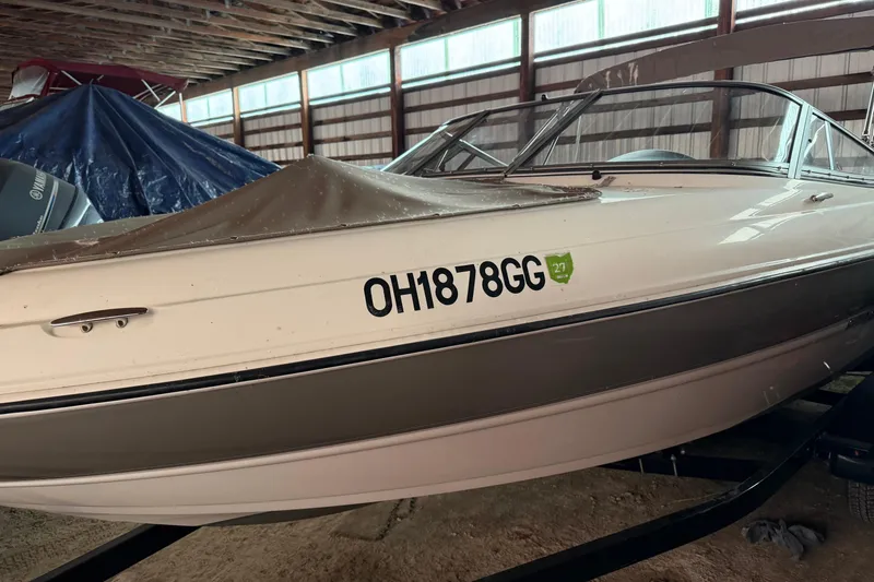Slide: The Image of 2019 Stingray 208 LS boat in storage, covered, with registration number OH1878GG. - 5