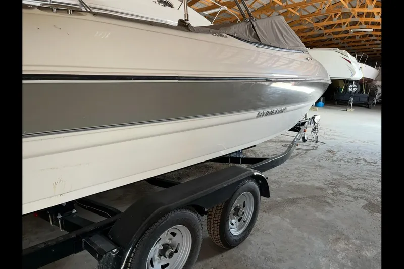 Slide: The Image of 2019 Stingray 208 LS boat on trailer in storage facility. - 8