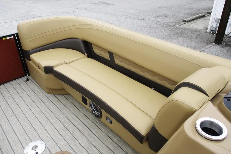 Slide: The Image of Luxurious seating on 2026 SunCatcher Fusion 322RC boat, featuring beige upholstery and cup holder. - 15