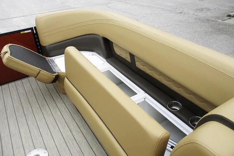 Slide: The Image of 2026 SunCatcher Fusion 322RC boat interior with tan seating and storage compartments. - 16