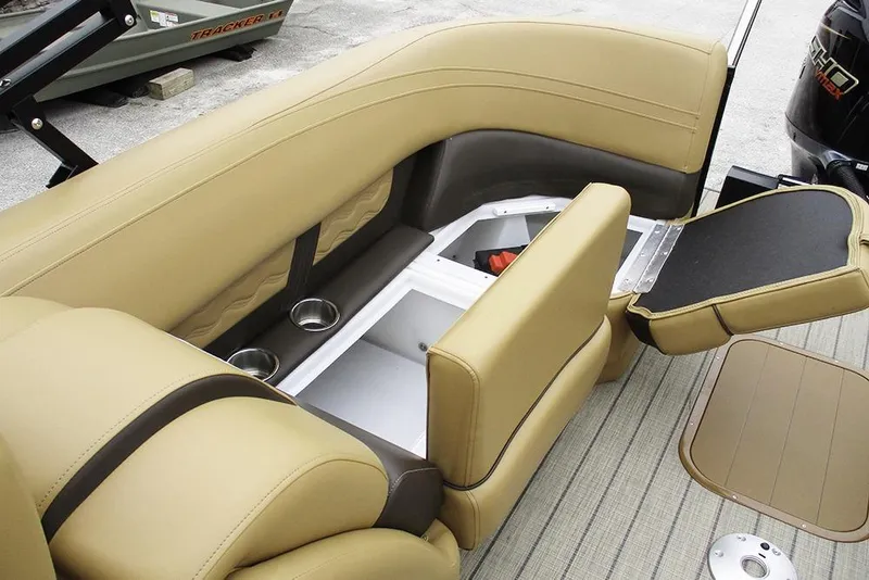 Slide: The Image of 2026 SunCatcher Fusion 322RC boat interior with tan seating and storage compartments. - 22