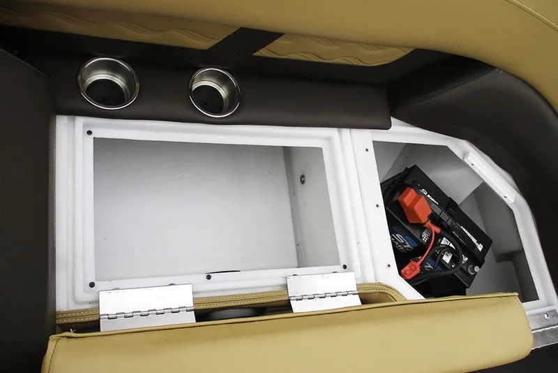 Slide: The Image of Interior storage compartment of 2026 SunCatcher Fusion 322RC with battery and cup holders. - 23