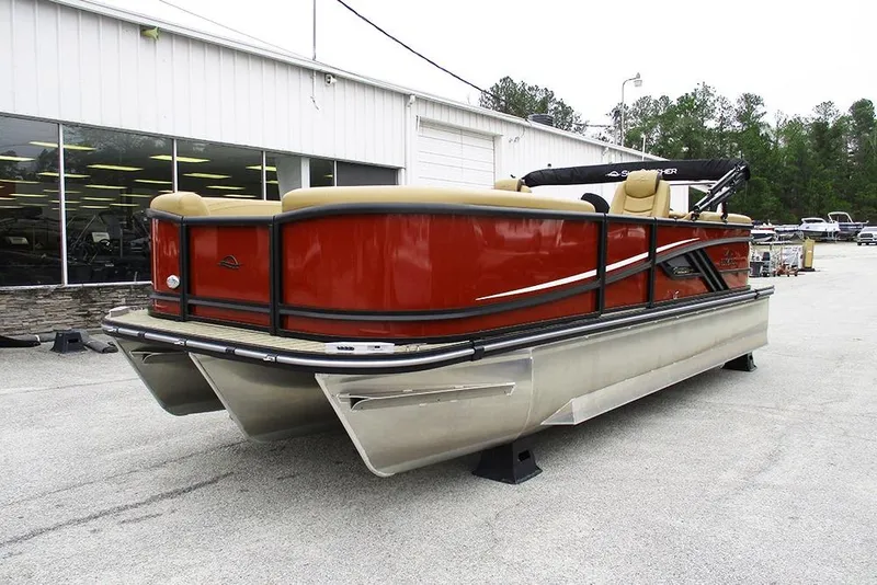 Slide: The Image of 2026 SunCatcher Fusion 322RC pontoon boat with red exterior, displayed outdoors. - 5