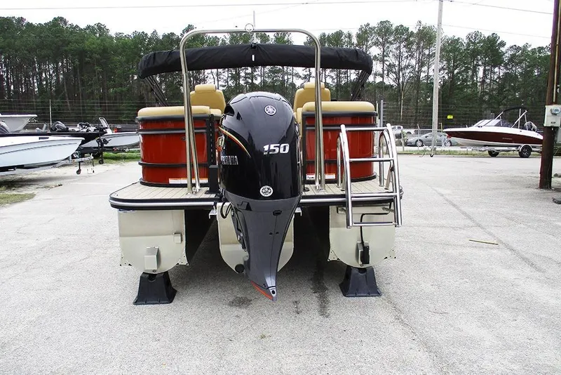 Slide: The Image of 2026 SunCatcher Fusion 322RC pontoon boat with Yamaha 150 outboard motor, parked outdoors. - 8